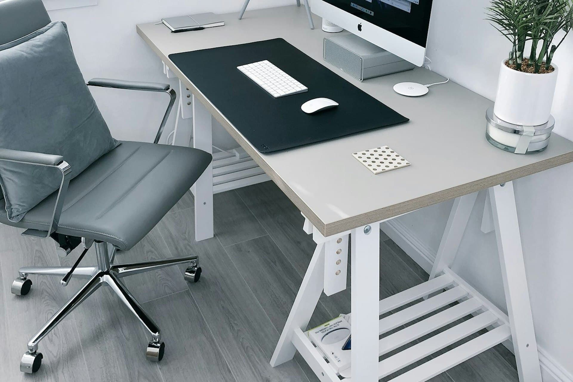 Minimalist office desk positioned beside a window