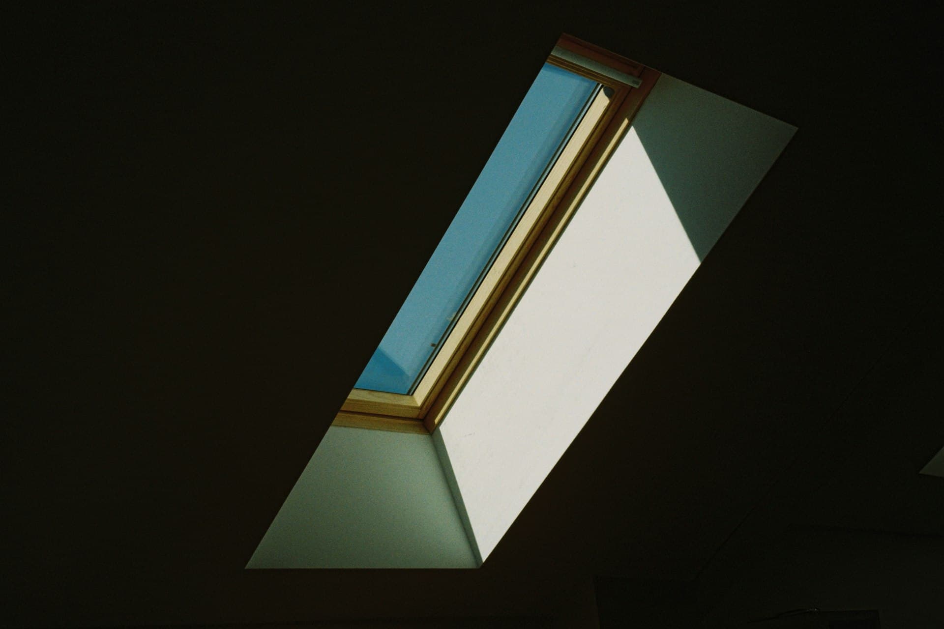 Angled Velux window frame glowing with daylight