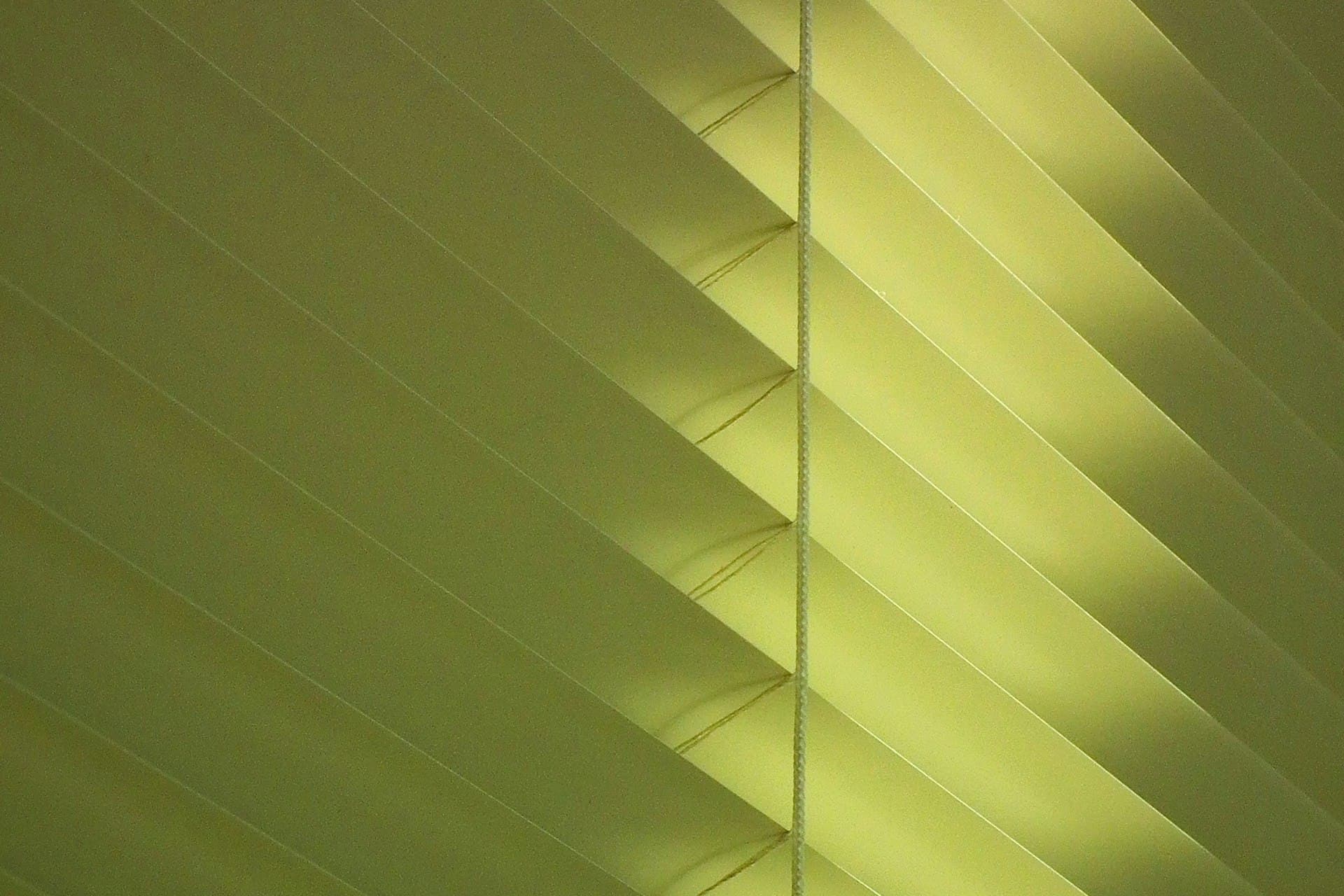 White pleated blind fabric texture with a cushion